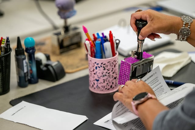 A Service Center employee demonstrates the preparation of documents at the IRS Processing Facility on September 06, 2024, in Austin, Texas.