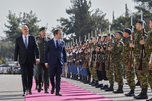 Greek Defense Minister Nikos Dendias, front left, and his French counterpart Sebastien Lecornu, front right, inspect the guard of honour before their meeting in Athens, Greece, Monday, April 14, 2025. (AP Photo/Petros Giannakouris)