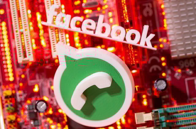 3D printed Whatsapp and Facebook logos are placed on a computer motherboard in this illustration taken January 21, 2021. REUTERS/Dado Ruvic/Illustration