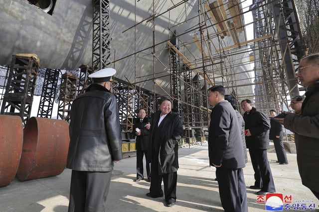 In this undated photo provided on March 8, 2025, by the North Korean government, North Korean leader Kim Jong Un, center, visits a shipyard to construct warships at an undisclosed place in North Korea. This image could not be independently verified.