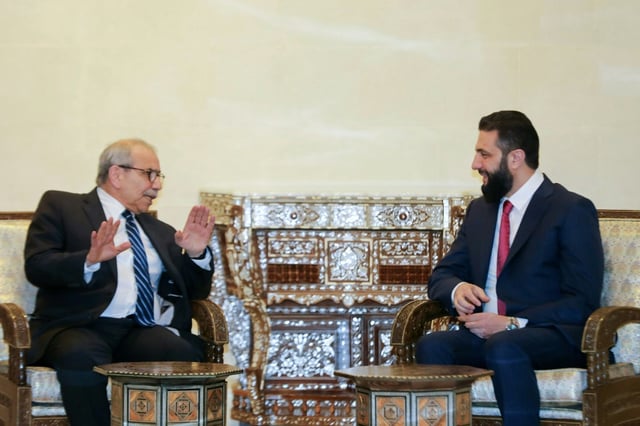 A handout picture released by the Lebanese government shows Prime Minister Nawaf Salam (L) meeting Syrian leader Ahmed al-Sharaa in Damascus on Monday