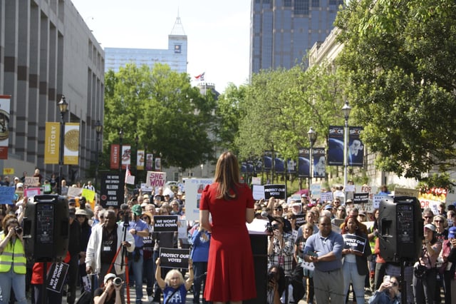 Democratic Associate Justice Allison Riggs stands before more than a hundred supporters at her rally in Raleigh, N.C., on Monday, April 14, 2025. (AP Photo/Makiya Seminera)