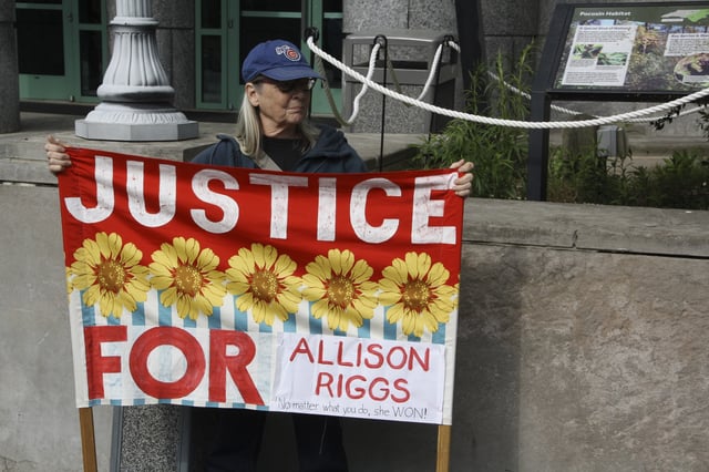 A protester waits for Democratic Associate Justice Allison Riggs to address supporters in Raleigh, N.C., on Monday, April 14, 2025. (AP Photo/Makiya Seminera)