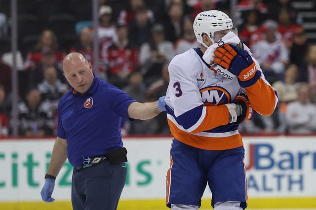 Apr 13, 2025; Newark, New Jersey, USA; New York Islanders defenseman Adam Pelech (3) leaves the ice after being hit by New Jersey Devils center Paul Cotter (47) (not pictured) during the second period at Prudential Center. Mandatory Credit: Ed Mulholland-Imagn Images