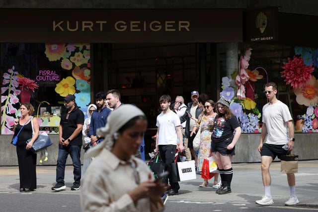 Shoppers walk past a Kurt Geiger retail store on Oxford Street in London, Britain, August 27, 2024. REUTERS/Hollie Adams/File Photo