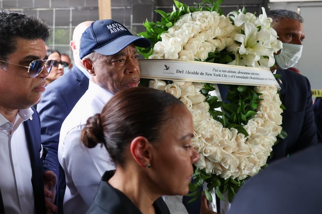 New York City Mayor Eric Adams carries a wreath as he visits the remains of the Jet Set nightclub after a deadly roof collapse, in Santo Domingo, Dominican Republic April 14, 2025. REUTERS/Ricardo Arduengo