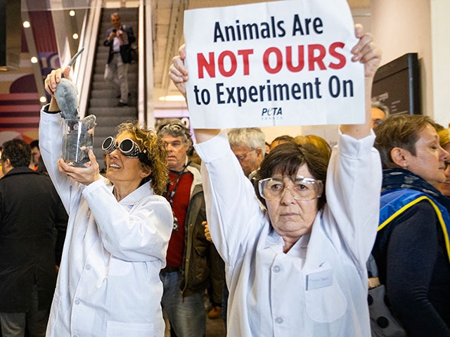 Activists of the People for the Ethical Treatment of Animals (PETA) hold placards which read "Sanofi: Stop the mad scientists, Stop the forced swimming tests" as they protest against animal testing by French multinational pharmaceutical and healthcare company Sanofi on the sidelines of the company's general assembly at the Palais des Congres in Paris, on April 30, 2024. (Photo by Antonin UTZ / AFP) (Photo by ANTONIN UTZ/AFP via Getty Images)