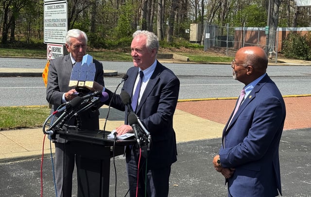 Sen. Chris Van Hollen (D-Md.) holds a model of the Roman Space Telescope outside the Goddard Space Flight Center, flanked by (left) Rep. Steny Hoyer (D-Md.) and Glenn Ovey (D-Md.)