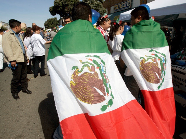 Roberto Cervantes (left) and Oscar Valdez draped themselves with Mexican flags at the Cinco de Mayo festival and parade on International Boulevard in Oakland, Calif. on Saturday, May 5, 2007.