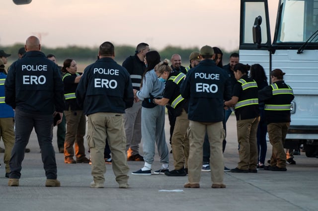 A woman in shackles is patted down before boarding the first deportation flight of undocumented Venezuelans after a US-Venezuelan agreement in Harlingen, Texas, on October 18, 2023.