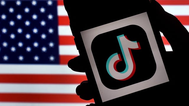 In this photo illustration, the social media application logo, TikTok is displayed on the screen of an iPhone on an American flag background on August 3, 2020 in Arlington, Virginia.