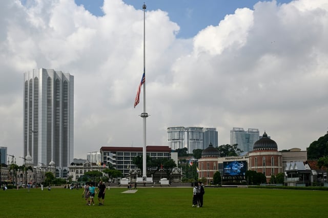 The giant Malaysian flag at Merdeka (Independence) Square flies at half mast in honour of Abdullah following his death at the age of 85