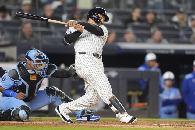 Apr 14, 2025; Bronx, New York, USA; New York Yankees center fielder Trent Grisham (12) hits a home run against the Kansas City Royals during the fifth inning at Yankee Stadium. Mandatory Credit: Gregory Fisher-Imagn Images