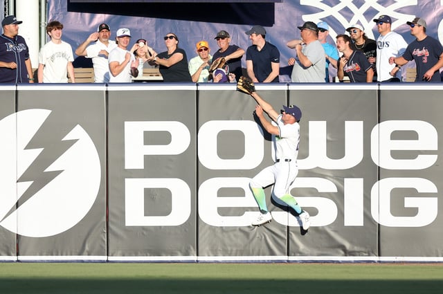 Apr 12, 2025; St. Petersburg, Florida, USA;  Tampa Bay Rays outfielder Kameron Misner (26) jumps as a fan catches the home run ball during the ninth inning against the Atlanta Braves at George M. Steinbrenner Field. Mandatory Credit: Kim Klement Neitzel-Imagn Images