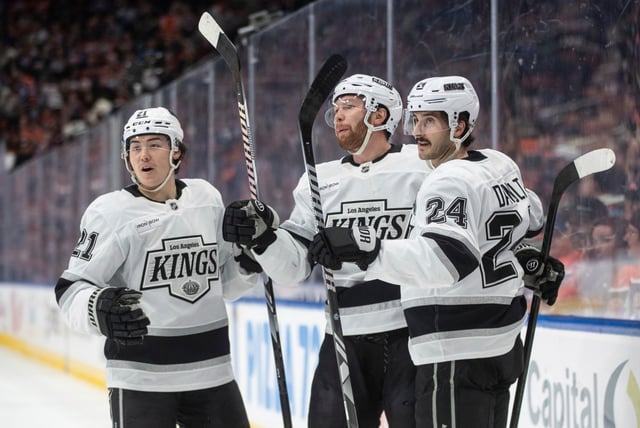 The Kings’ Jordan Spence, left, Vladislav Gavrikov, center, and Phillip Danault celebrate after a goal during the first period of their game against the Edmonton Oilers on Monday night in Edmonton, Alberta. The Kings won, 5-0. (Jason Franson/The Canadian Press via AP)