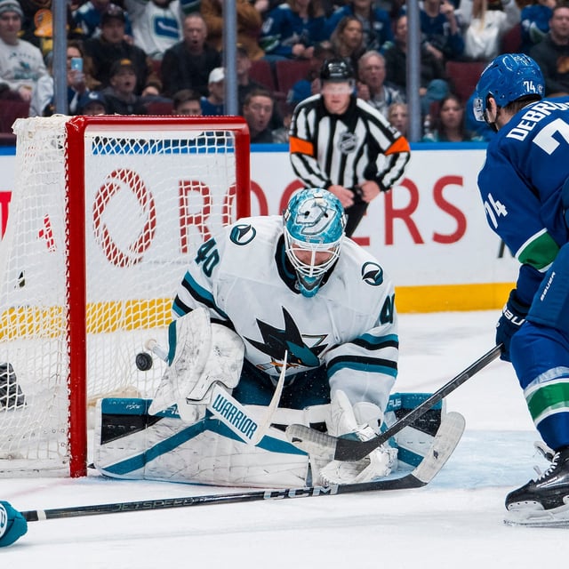 Apr 14, 2025; Vancouver, British Columbia, CAN; Vancouver Canucks forward Jake DeBrusk (74) scores on San Jose Sharks goalie Alexandar Georgiev (40) in overtime at Rogers Arena. Mandatory Credit: Bob Frid-Imagn Images