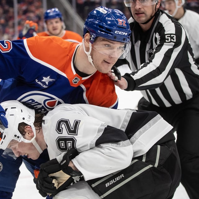 Los Angeles Kings' Brandt Clarke (92) and Edmonton Oilers' Vasily Podkolzin (92) rough ti up during second period NHL action in Edmonton, Monday, April 14, 2025. THE CANADIAN PRESS/Jason Franson