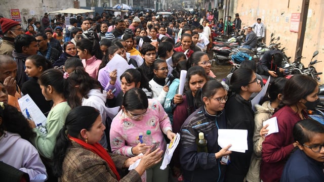 Aspirants standing in queue before appearing in the JEE Mains exam at an examination centre in Patna.
