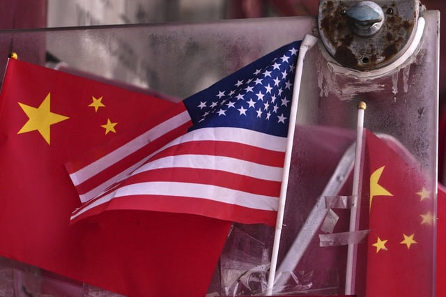 China and U.S. national flags are seen on display on an entrance door of a souvenir shop in Beijing on April 3, 2025. (AP Photo/Andy Wong)