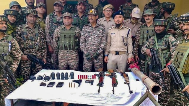 Security personnel with arms and ammunition recovered during a search operation in Kangpokpi district. (Manipur Police)