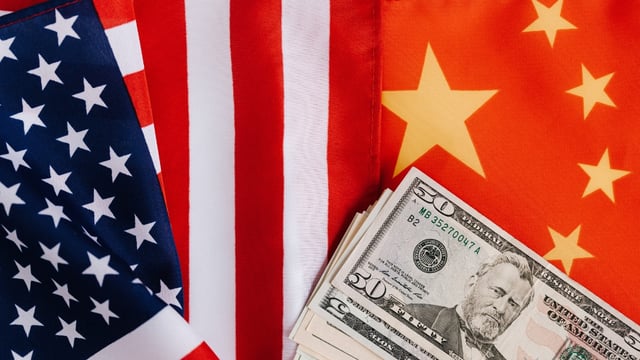 money on American and Chinese flags