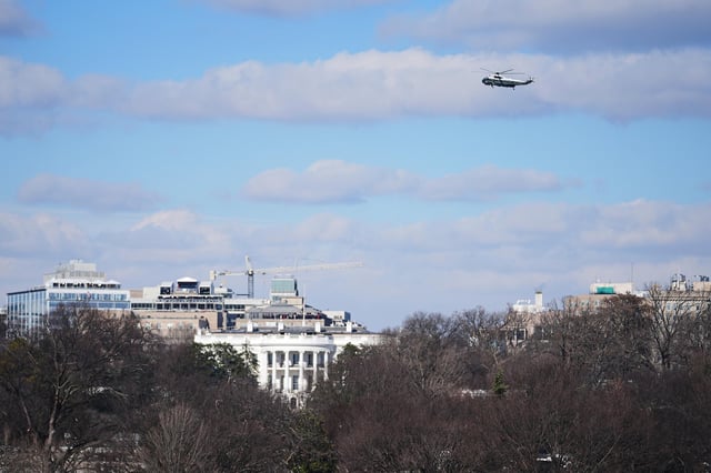 A helicopter carrying the Bidens flies over the White House following President Donald Trump's inauguration on January 20, 2025.