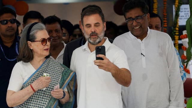 Rahul Gandhi and Sonia Gandhi take a selfie at a polling station during the sixth phase of the general election, in New Delhi.