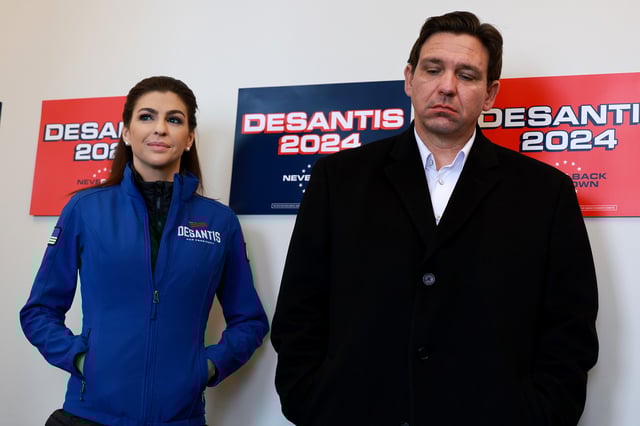 Republican presidential candidate Florida Governor Ron DeSantis and his wife Casey DeSantis look on during a campaign stop on January 13, 2024, in Atlantic, Iowa.