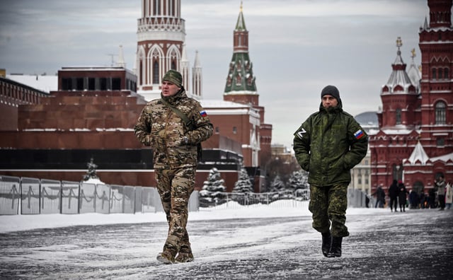 Men wearing military uniforms bearing a Z letter, an insignia of Russian troops in Ukraine, walk along the Red square in Moscow, on January 19, 2024.