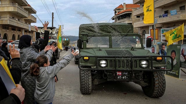 Hezbollah supporters throw rice at a Lebanese army jeep as it drives by, in Bint Jbeil, Lebanon, January 26, 2025 (DPA photo by Marwan Naamani via AP Images).