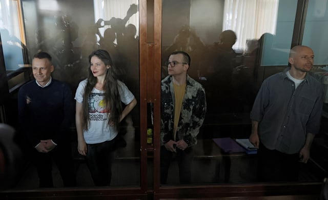 Journalists Konstantin Gabov, Antonina Favorskaya, Artem Kriger and Sergei Karelin, accused of taking part in the activities of an "extremist" organization founded by late opposition politician Alexei Navalny, stand inside an enclosure for defendants before a court hearing in Moscow, Russia October 2, 2024. REUTERS/Maxim Shemetov/File Photo