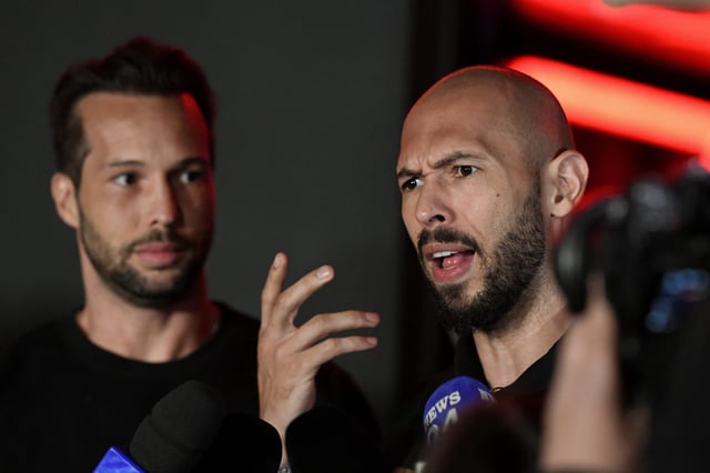 Andrew Tate, right, delivers a press statement in front of his house after landing back in Romania, near Bucharest, on March 22, 2025.