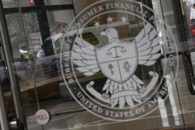 Demonstrators take part in a protest by the Consumer Financial Protection Bureau (CFPB) building, the day after members of Elon Musk's Department of Government Efficiency (DOGE) moved into the CFPB, in Washington, U.S. February 8, 2025. REUTERS/Nathan Howard/File Photo