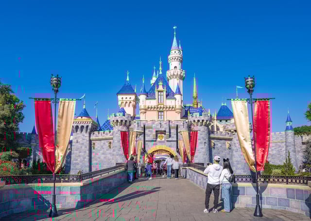 Theme park visitors prepare to enter Sleeping Beauty Castle at Disneyland on January 18, 2025, in Anaheim, California.