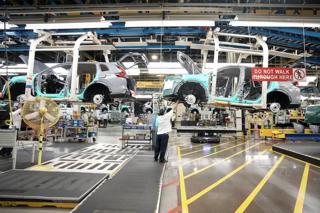 Honda employees work along the vehicle assembly line before an event announcing plans for a Honda electric vehicle battery plant in Alliston, Ont., on April 25, 2024. 