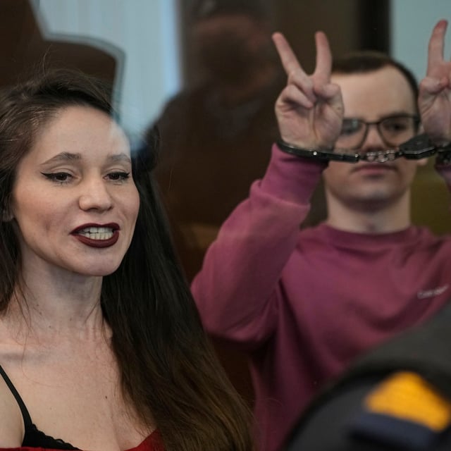 Russian journalists, Antonina Favorskaya, left, and Artyom Kriger, accused of working for a group founded by the late Russian opposition politician Alexei Navalny, stand in a defendant's cage of the Nagatinsky District Court in Moscow, Russia, on Tuesday, April 15, 2025. (AP Photo)
