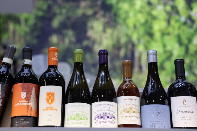 Bottles of wine from Tuscany are displayed inside a pavillion at the wine and spirits fair Vinitaly which occurs amid the newly imposed U.S. tariffs, inlcuding the European Wine imports, in Verona, Italy, April 6, 2025. REUTERS/Claudia Greco/File Photo