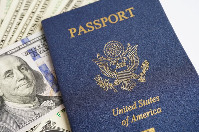 A photo of a U.S. passport, which is REAL ID compliant, is accompanied by U.S. currency.