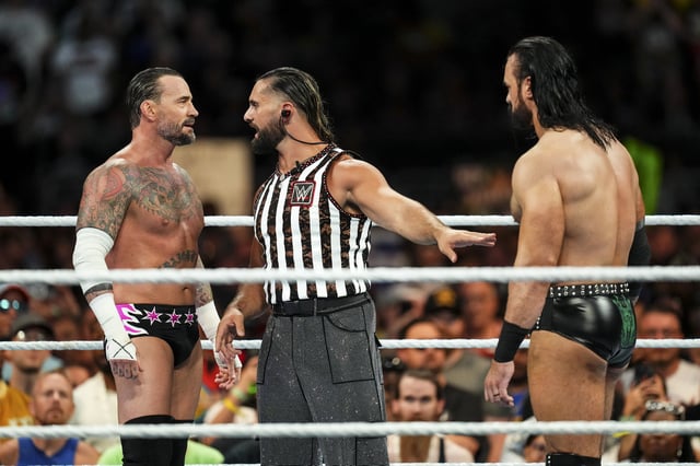 CLEVELAND, OHIO - AUGUST 03: CM Punk, Seth Rollins and Drew McIntyre have words during SummerSlam at Cleveland Browns Stadium on August 3, 2024 in Cleveland, Ohio.
