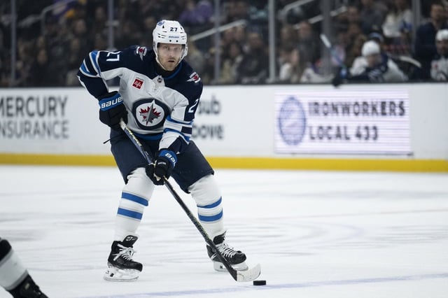 Winnipeg Jets left wing Nikolaj Ehlers (27) controls the puck during an NHL hockey game against the Los Angeles Kings, Tuesday, April 1, 2025, in Los Angeles. (AP Photo/Kyusung Gong)