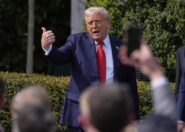 President Donald Trump gestures to the crowd as he departs after welcoming the 2025 College Football National Champions, the Ohio State University football team, during an event on the South Lawn of the White House, Monday, April 14, 2025, in Washington. (AP Photo/Manuel Balce Ceneta)