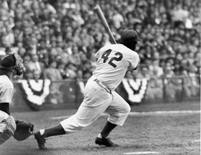 American baseball player Jackie Robinson (1919 - 1972) of the Brooklyn Dodgers at bat during a game, 1940s or 1950s.