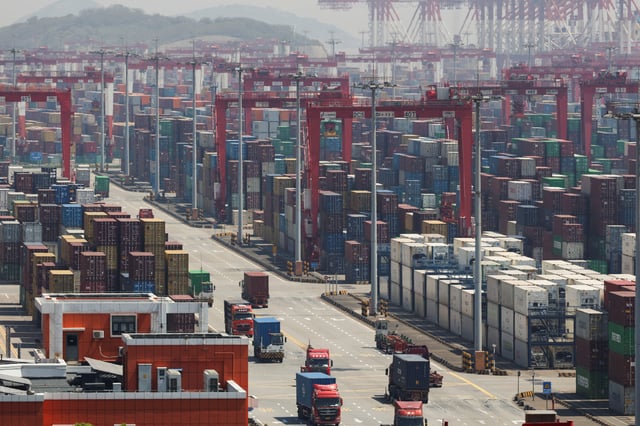 Gantry cranes stand near shipping containers at Yangshan Port outside of Shanghai, China, April 15, 2025.  REUTERS/Go Nakamura/File Photo