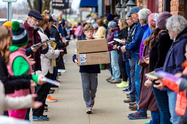 People help transfer books for Serendipity Books in Chelsea, Mich.
