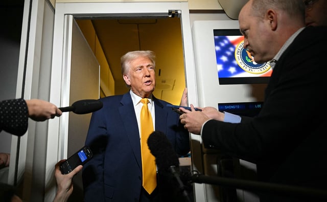 US President Donald Trump speaks to reporters during the flight from Palm Beach to Miami aboard Air Force One on April 12, 2025.
