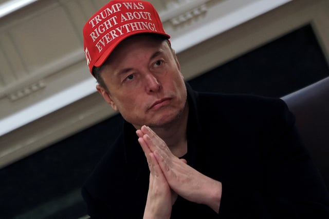 Tesla CEO Elon Musk wears a 'Trump Was Right About Everything!' hat while attending a cabinet meeting at the White House, in Washington, D.C., U.S., March 24, 2025. REUTERS/Carlos Barria/File Photo/File Photo