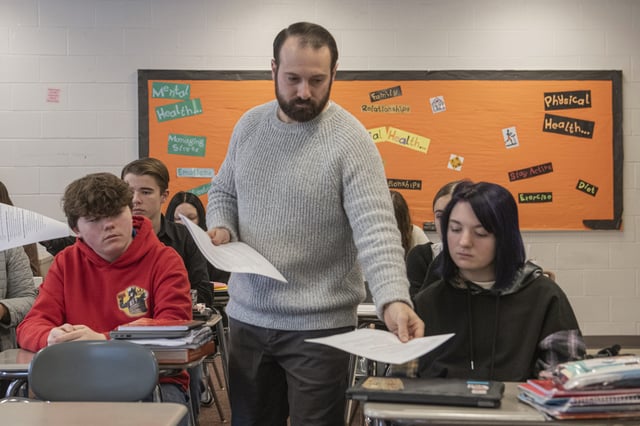 Mansfield Senior High School teacher Tony Davis hands out work sheets to his health class about the topic of sleep Friday, Dec. 6, 2024, in Mansfield, Ohio. (AP Photo/Phil Long)