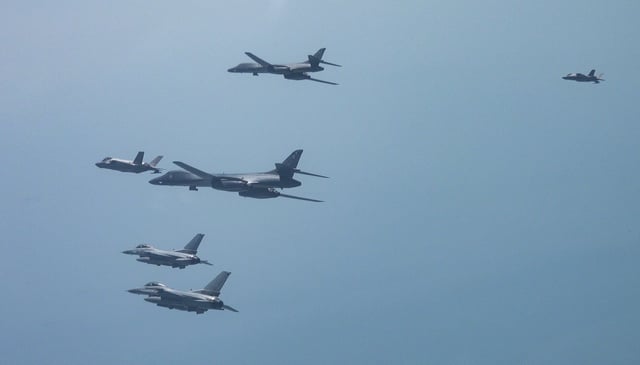 Two United States Air Force B-1B bombers fly in formation with two American F-16 fighter jets and two South Korean F-35A stealth fighter aircraft in airspace over the western region of South Korea on April 15, 2025.