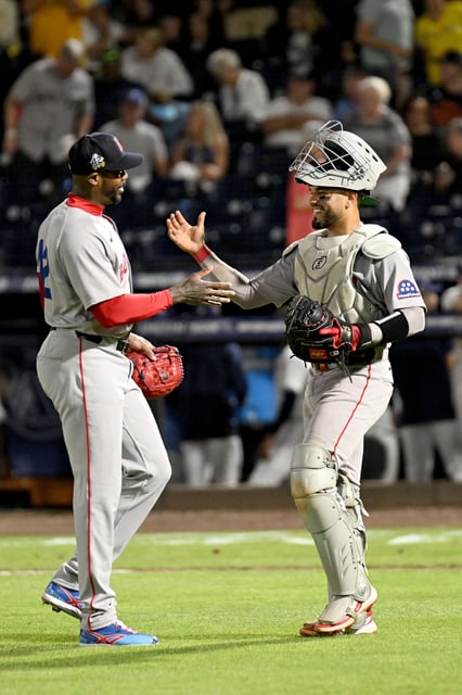 Apr 15, 2025; St. Petersburg, Florida, USA; Boston Red Sox relief pitcher Aroldis Chapman (42) and catcher Carlos Narvaez (75) celebrate after defeating the Tampa Bay Rays  at George M. Steinbrenner Field.  All Players wore #42 in honor of Jackie Robinson Day.. Mandatory Credit: Jonathan Dyer-Imagn Images