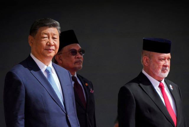 Malaysian King Sultan Ibrahim Sultan Iskandar, right, stands next to Chinese President Xi Jinping, left, and Malaysian Prime Minister Anwar Ibrahim, behind, during official welcoming ceremony at national palace in Kuala Lumpur, Malaysia, Wednesday, April 16, 2025. Vincent Thian/Pool via REUTERS